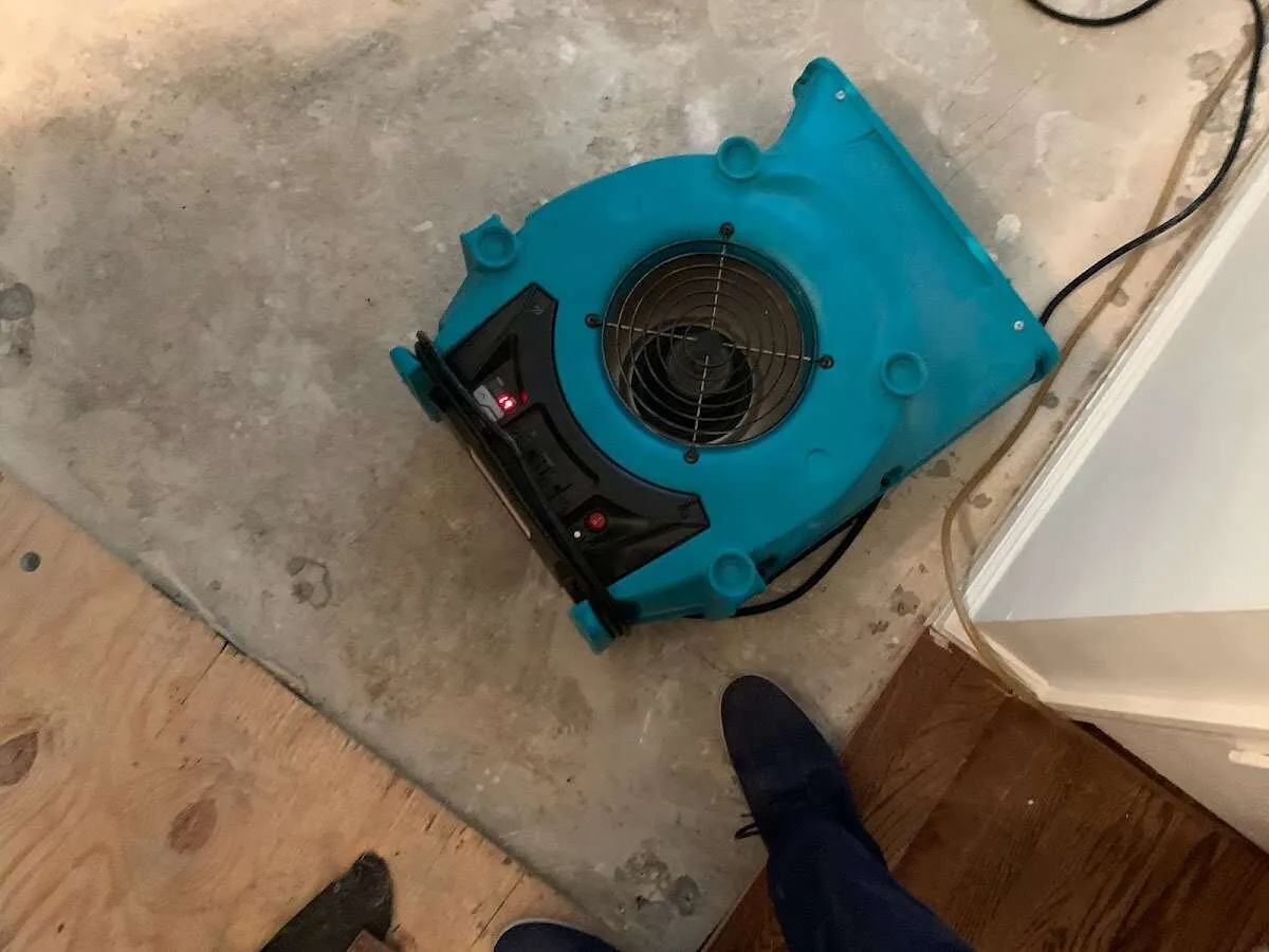 Air mover drying subfloor during Leak Detection & Repair in New Boston
